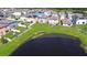 Lakeside homes with green lawns at 15505 Wicked Strong St, Sun City Center, FL 33573