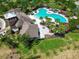 An aerial view showcases the community pool, clubhouse, and landscaping of this neighborhood, highlighting its amenities at 15505 Wicked Strong St, Sun City Center, FL 33573