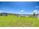 Expansive backyard overlooking a serene lake, perfect for outdoor activities and relaxation at 15505 Wicked Strong St, Sun City Center, FL 33573