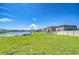 Expansive backyard overlooking a serene lake with lush green grass, perfect for outdoor enjoyment and relaxation at 15505 Wicked Strong St, Sun City Center, FL 33573
