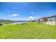 Spacious backyard featuring a scenic lake view and well-maintained lawn, great for recreation and relaxation at 15505 Wicked Strong St, Sun City Center, FL 33573