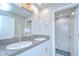 Bathroom featuring double sink vanity with granite countertops, large mirror, and shower-tub combination at 15505 Wicked Strong St, Sun City Center, FL 33573