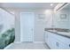 Bright bathroom featuring a double sink vanity with granite counters and decorative shower curtain at 15505 Wicked Strong St, Sun City Center, FL 33573