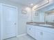 Well-lit bathroom with double sinks, granite countertops, and white cabinetry at 15505 Wicked Strong St, Sun City Center, FL 33573