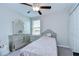 Bedroom features a bed, window for natural light, dresser with mirror, and closet with sliding door at 15505 Wicked Strong St, Sun City Center, FL 33573