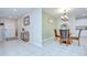 Open concept dining area showcasing tile flooring, a modern light fixture, and kitchen access at 15505 Wicked Strong St, Sun City Center, FL 33573