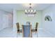 Cozy dining area with a round table and modern lighting fixture at 15505 Wicked Strong St, Sun City Center, FL 33573