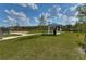 A picture of the lush green dog park and a shaded picnic area with blue roofing and picnic tables at 15505 Wicked Strong St, Sun City Center, FL 33573