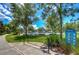 Outdoor exercise area with parallel bars, lush green grass, and shade trees creating a peaceful fitness environment at 15505 Wicked Strong St, Sun City Center, FL 33573