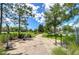 Scenic view of outdoor exercise park with paved path, exercise equipment, and lush landscaping under a sunny sky at 15505 Wicked Strong St, Sun City Center, FL 33573