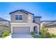 Two-story home featuring gray stucco, a gray garage door, and an arched entryway at 15505 Wicked Strong St, Sun City Center, FL 33573