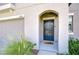 Inviting front entrance with a dark blue door, a digital lock, and a welcome mat at 15505 Wicked Strong St, Sun City Center, FL 33573