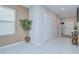 Welcoming foyer with tile flooring, a decorative plant, and an open view to the staircase at 15505 Wicked Strong St, Sun City Center, FL 33573
