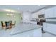 Open kitchen and dining room concept featuring a large island and granite countertops at 15505 Wicked Strong St, Sun City Center, FL 33573