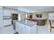 Open kitchen and living room concept with granite counters and stainless steel appliances at 15505 Wicked Strong St, Sun City Center, FL 33573