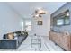 Well-lit living room features contemporary decor, a ceiling fan, and a large television at 15505 Wicked Strong St, Sun City Center, FL 33573