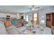 Cozy living space showcasing a large sectional and open layout to the kitchen at 15505 Wicked Strong St, Sun City Center, FL 33573