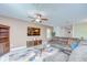 Open-concept living room with stylish furnishings and a view into the dining area at 15505 Wicked Strong St, Sun City Center, FL 33573