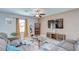 Comfortable living room featuring a large sofa, modern decor, and ample natural light at 15505 Wicked Strong St, Sun City Center, FL 33573
