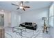 Cozy living room features a ceiling fan, modern decor, and a large window at 15505 Wicked Strong St, Sun City Center, FL 33573