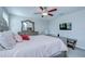 Comfortable main bedroom with neutral tones, a large mirror, and a ceiling fan at 15505 Wicked Strong St, Sun City Center, FL 33573