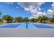 Well-maintained blue and gray pickleball court with a covered bench, providing a community space for sports and recreation at 15505 Wicked Strong St, Sun City Center, FL 33573
