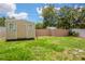 Backyard featuring lawn, landscaping, and a storage shed at 1621 Crossridge Dr, Brandon, FL 33510