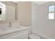 Bright bathroom featuring a white vanity with granite counters, a mirror, and a shower over a tub with a window at 1621 Crossridge Dr, Brandon, FL 33510