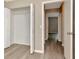 Bedroom with closet and view to other rooms, featuring neutral-toned walls and wood-look flooring at 1621 Crossridge Dr, Brandon, FL 33510