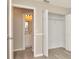 Neutral bedroom features a closet with bi-fold doors, light wood flooring, and a bathroom at 1621 Crossridge Dr, Brandon, FL 33510