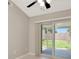 Bedroom with a sliding glass door which leads to a lush green backyard at 1621 Crossridge Dr, Brandon, FL 33510
