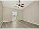 Bright bedroom featuring a ceiling fan, window, and sleek flooring at 1621 Crossridge Dr, Brandon, FL 33510