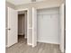 Bedroom closet with gray wood-look flooring, and bi-fold doors with wire shelving for ample storage at 1621 Crossridge Dr, Brandon, FL 33510