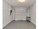 Spacious garage with white walls, concrete floor, electric door, and ample room for storage or a workshop at 1621 Crossridge Dr, Brandon, FL 33510
