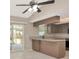 Kitchen featuring neutral countertops, brown cabinetry, tile flooring and a sliding glass door to the outside at 1621 Crossridge Dr, Brandon, FL 33510