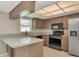 Bright kitchen with granite countertops and stainless steel appliances at 1621 Crossridge Dr, Brandon, FL 33510