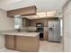 Bright kitchen with stainless steel appliances, granite counters, and warm wood cabinetry at 1621 Crossridge Dr, Brandon, FL 33510