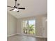 Inviting living room with large window, ceiling fan, and fresh neutral paint at 1621 Crossridge Dr, Brandon, FL 33510