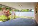 Covered patio area with concrete floor, plants, and white privacy fence at 1621 Crossridge Dr, Brandon, FL 33510