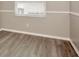 Bright room featuring gray wood-look flooring, a window and a white trim at 1621 Crossridge Dr, Brandon, FL 33510