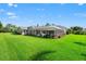 Expansive backyard with a screened-in pool area, lush landscaping, and plenty of space for outdoor activities at 17311 Carriage Way, Odessa, FL 33556