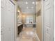 Serene bathroom with a soaking tub, elegant fixtures, and travertine tile at 17311 Carriage Way, Odessa, FL 33556
