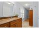 Bright bathroom showcases a vanity with granite countertop and wood cabinetry at 17311 Carriage Way, Odessa, FL 33556