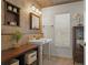 Charming bathroom with tiled walls, decorative sink with vanity, and a window for natural light at 17311 Carriage Way, Odessa, FL 33556
