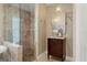 Bathroom with tiled walk-in shower and dark wood vanity at 17311 Carriage Way, Odessa, FL 33556