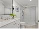 Modern bathroom with marble countertop, a sleek sink and a glass shower at 17311 Carriage Way, Odessa, FL 33556