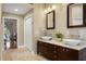 Bathroom with double sinks, marble counters, and a dark wood vanity at 17311 Carriage Way, Odessa, FL 33556