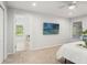Bright bedroom with a ceiling fan, plush carpet, and a serene view from the adjoining sunroom at 17311 Carriage Way, Odessa, FL 33556