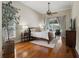 Bright bedroom with hardwood floors, crown molding, and view of the pool at 17311 Carriage Way, Odessa, FL 33556