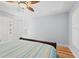 Cozy bedroom with light blue walls, plantation shutters, and a ceiling fan at 17311 Carriage Way, Odessa, FL 33556